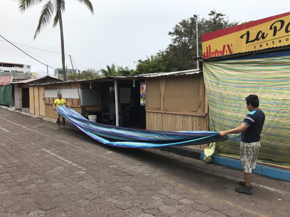 Folding the tarp after opening the restaurant