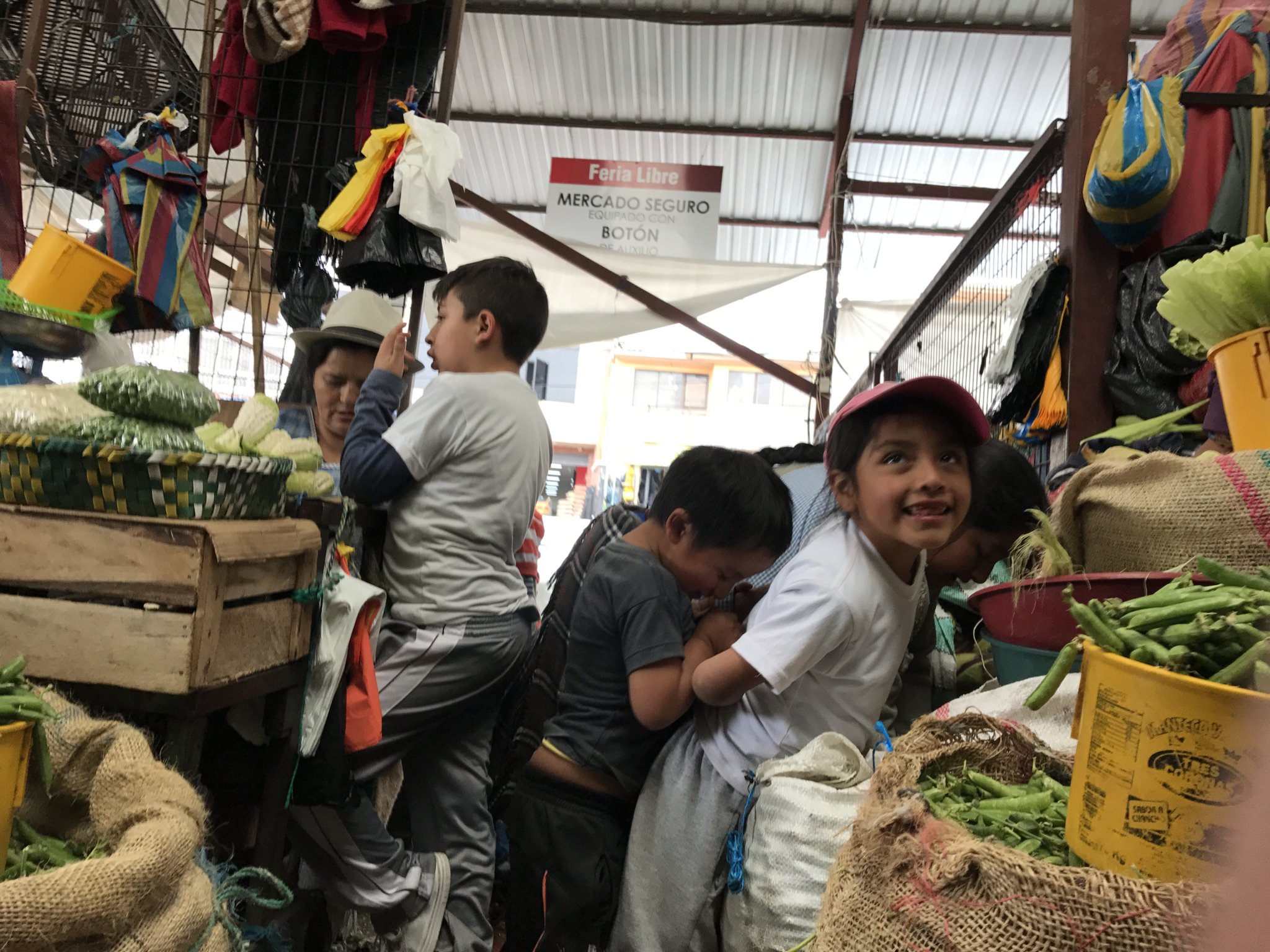 Kids were often helping their families at their stall - Feria Libre market, Cuenca