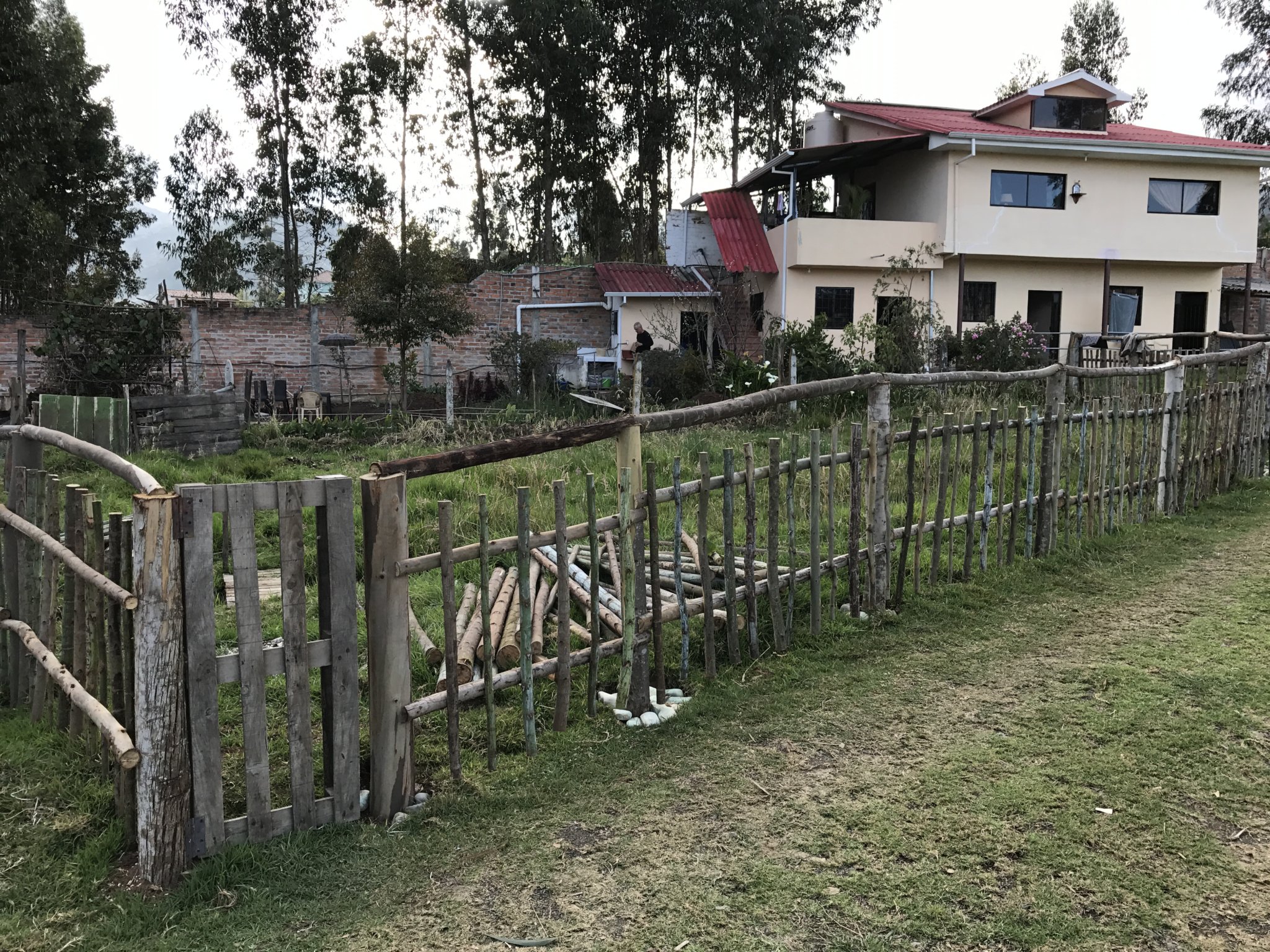 More than half the goat pen fence completed, with our awesome hinged gate in the corner