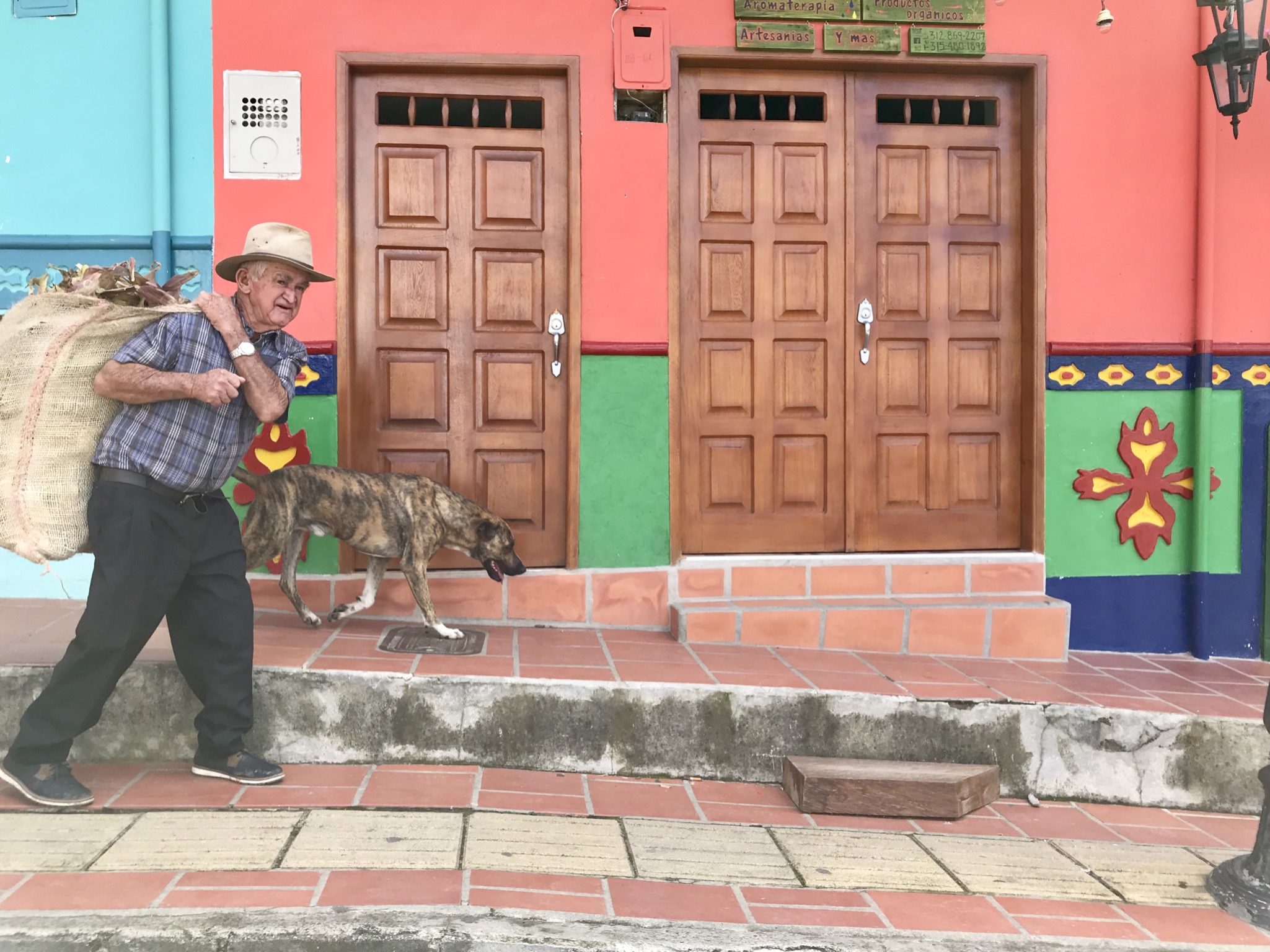 Man with dog and zocalos in Guatapé