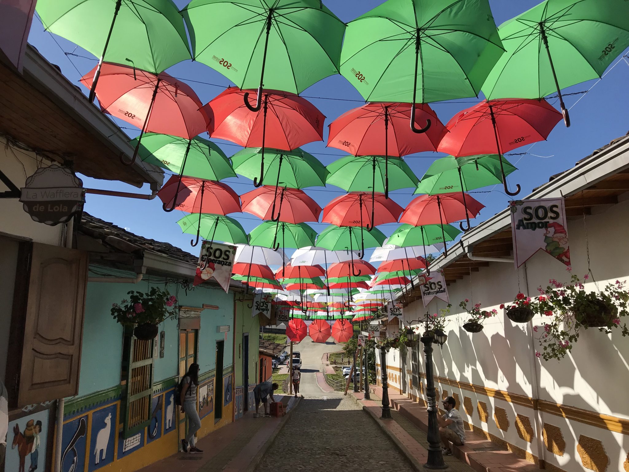 Festival umbrellas over a main street in Guatapé