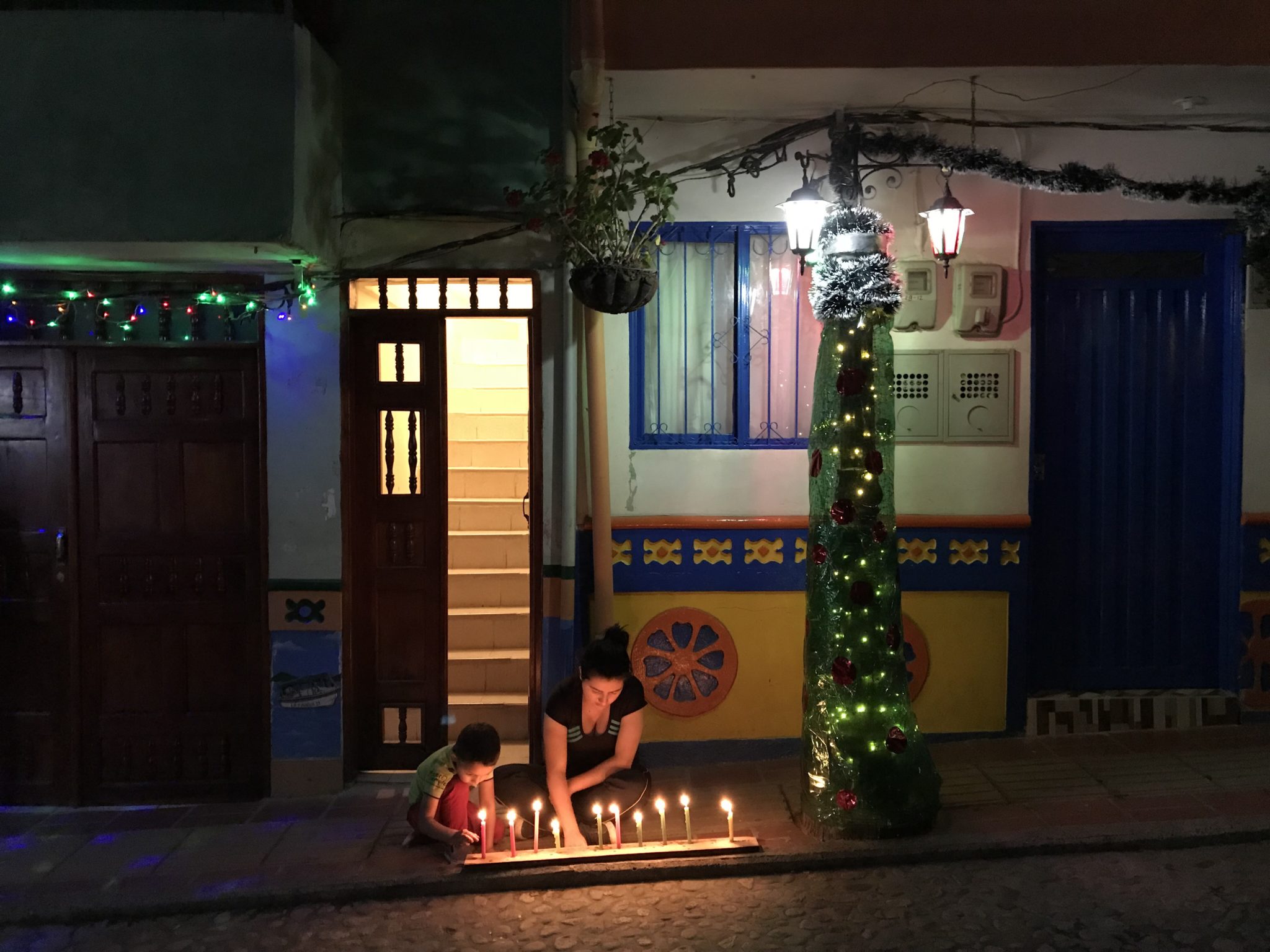 Lighting candles for Día de las Velitas on December 7 in Guatapé